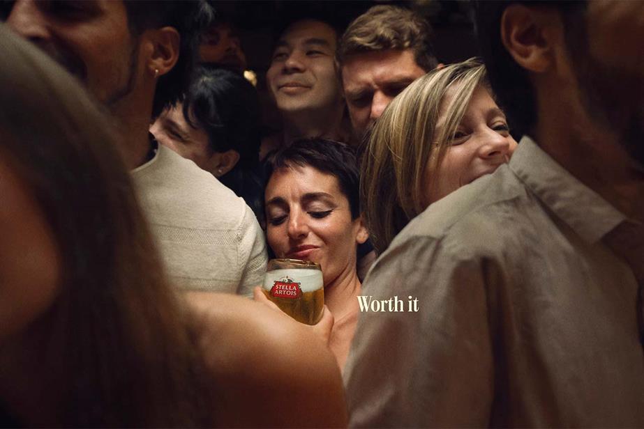 Woman in crowded bar with Stella Artois