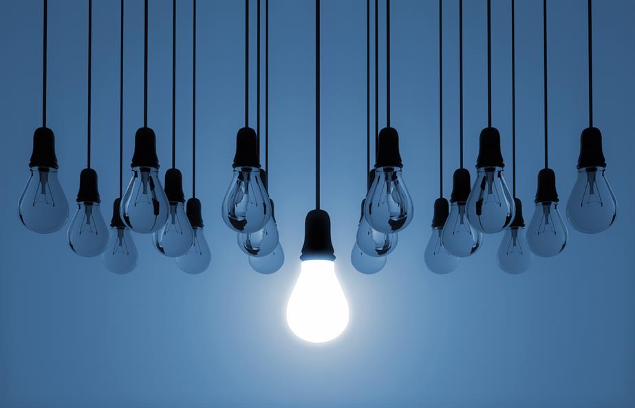 Hanging lightbulbs, with one lit up