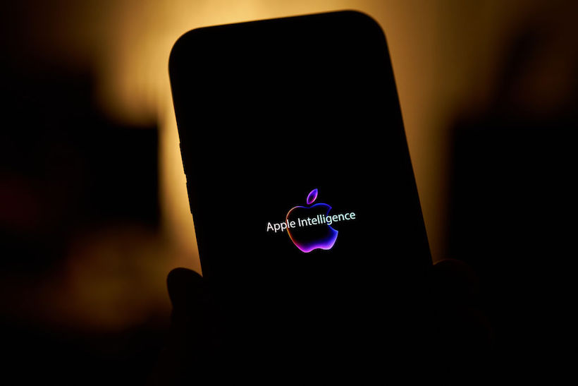 The Apple Intelligence logo is seen on an iPhone