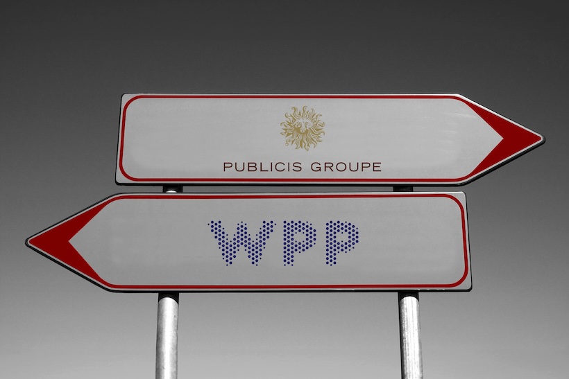Two signs pointing in opposite directions, one displaying the Publicis Groupe logo, the other displaying the WPP logo