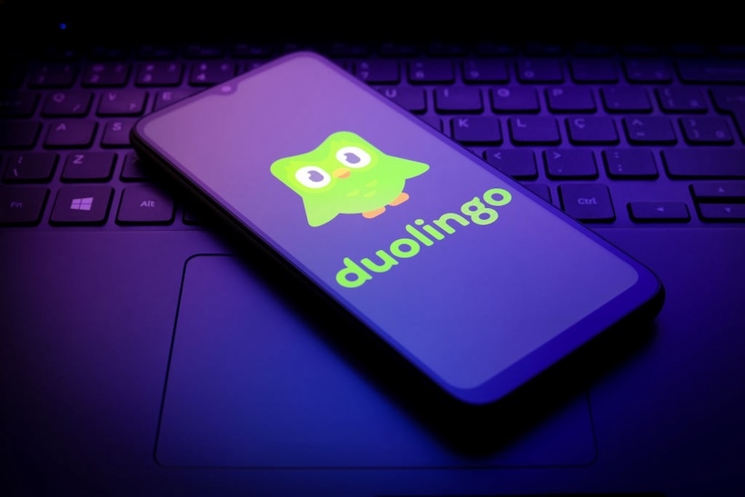 Smart phone displaying Duolingo logo and mascot