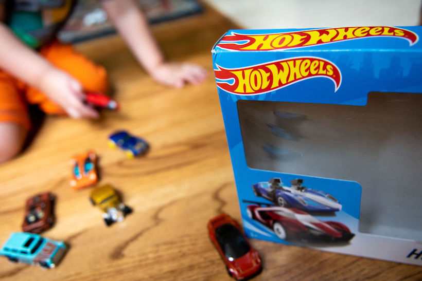 Child playing with Hot Wheels toys