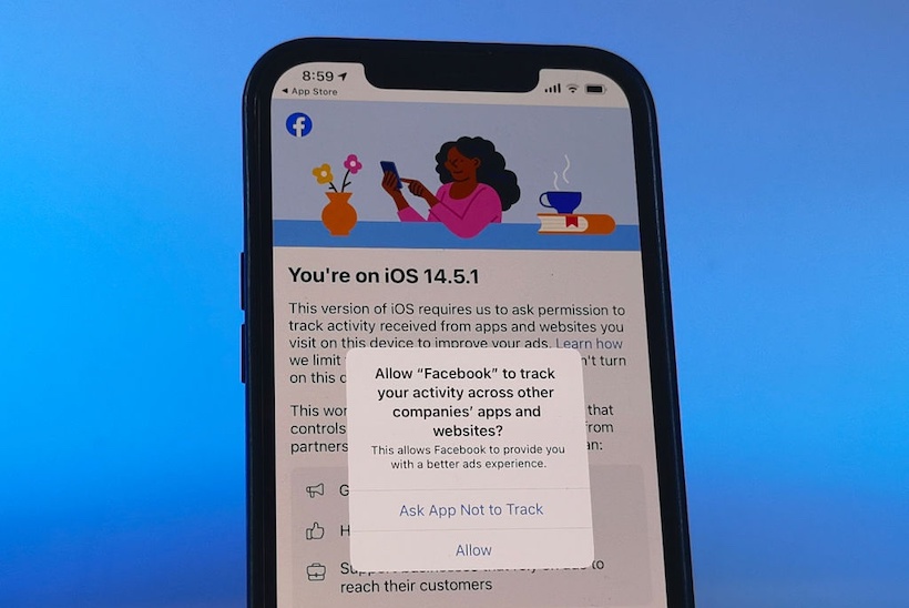 Smart phone displaying Facebook app asking to track user's activity