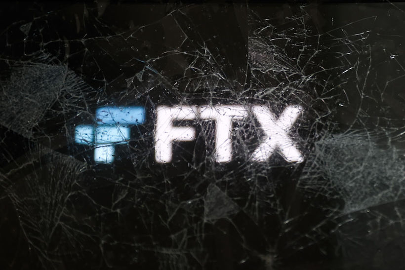 FTX logo behind shattered glass