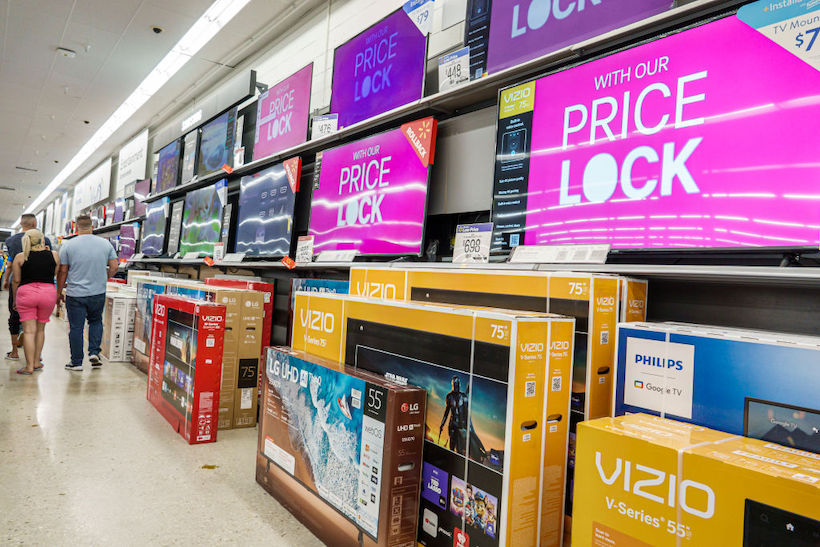 People shopping for wide screen TVs