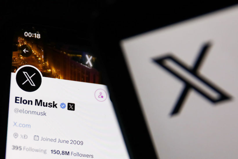 Smart phone displaying Elon Musks Twitter account and X logo