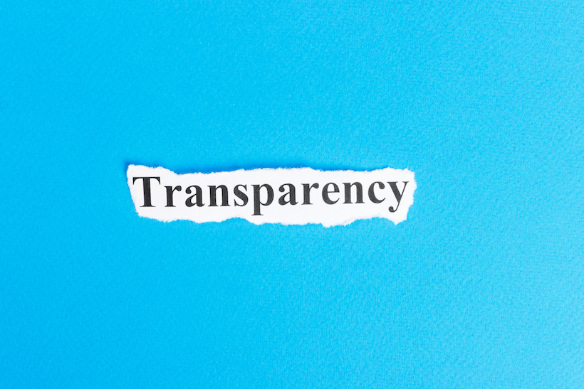 The word "transparency" is written on a piece of paper