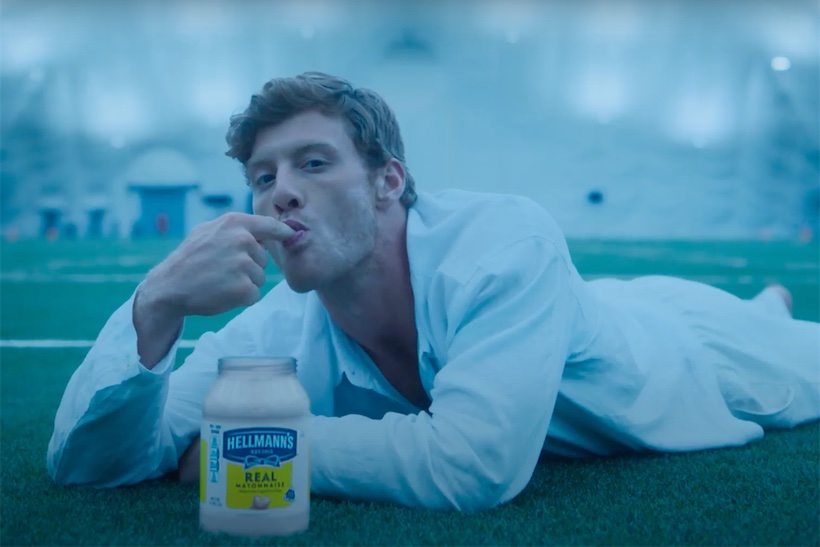 Man in bathrobe eating Hellmann's mayonnaise