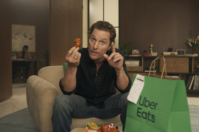 Matthew McConaughey holding a chicken wing