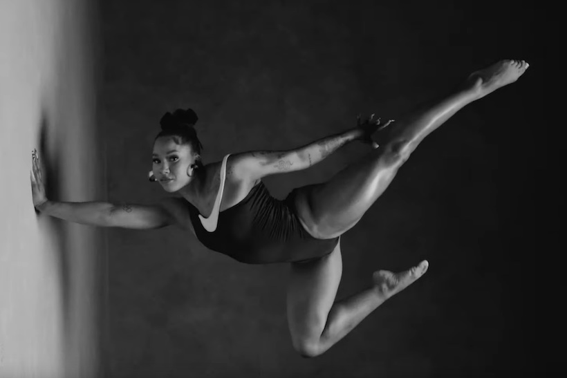 Black and white photo of gymnast Jordan Chiles in Nike leotard doing handstand.