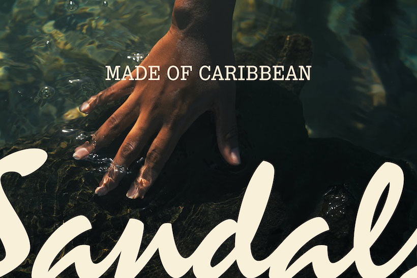 Hand reaching into water superimposed with text reading "Made of Caribbean" and "Sandals"