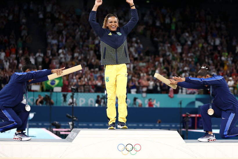 Simone Biles and Jordan Chiles bow to Rebeca Andrade on the podium at the Paris 2024 Olympic Games