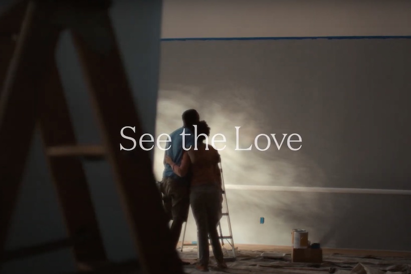 Two people looking at newly painted wall