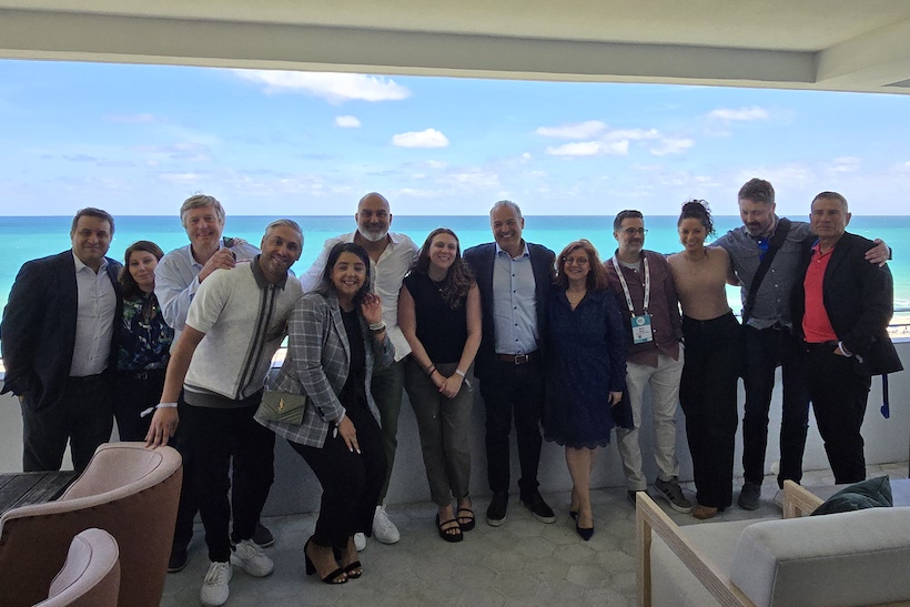 Group of people standing in front of ocean vista