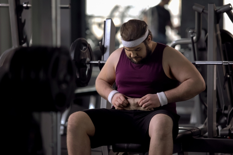 Plus-size man working out at gym