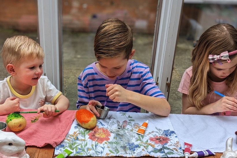 Children painting potatoes for easter
