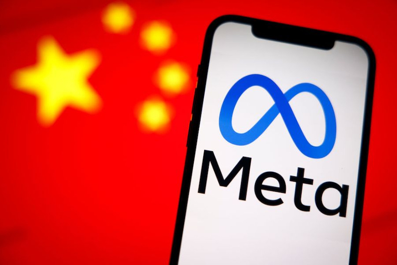 Smart phone displaying Meta logo in front of Chinese flag