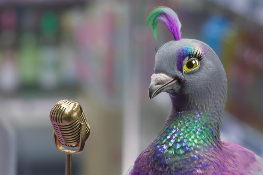 A colourful pigeon stands in front of a microphone 