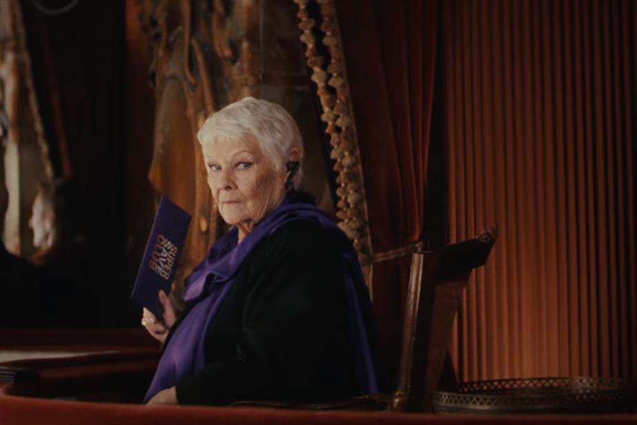 Dame Judi Dench in a theatre box, looking at the camera