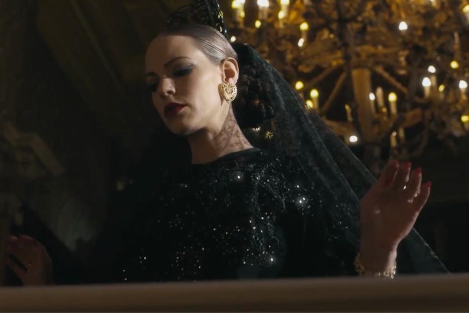 Woman removing black veil