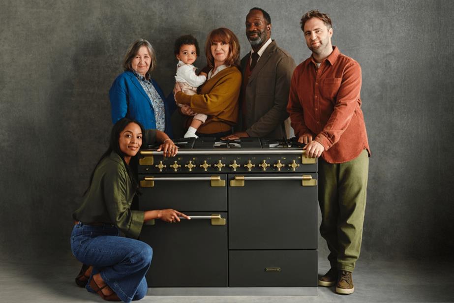 Family standing with a cooker