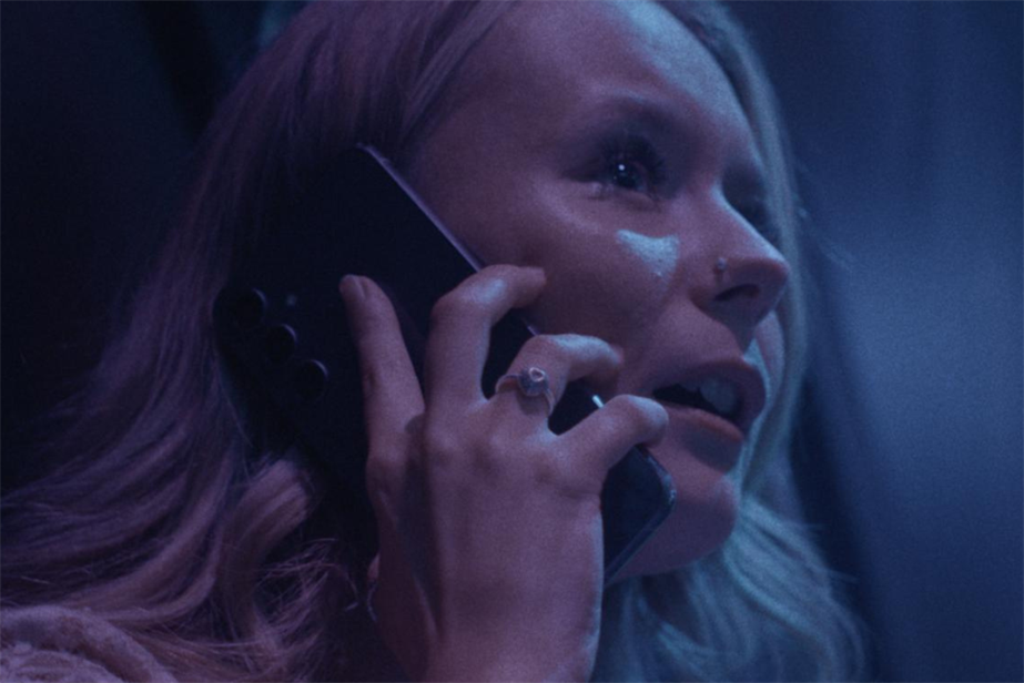 A young blonde girl speaking on her mobile