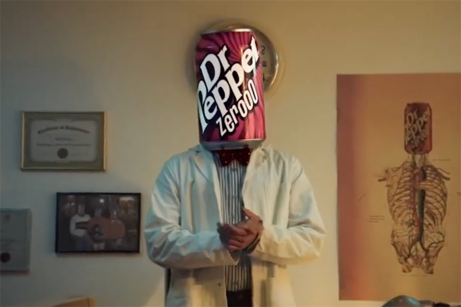 a man with a giant can of dr pepper on his head