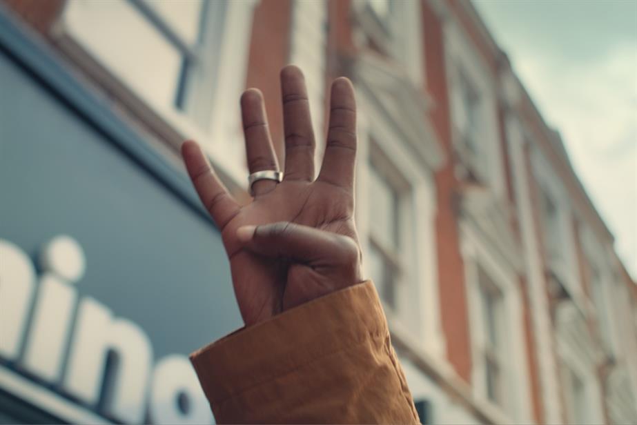 Person holding up four fingers