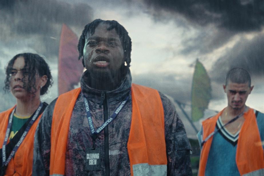 Three people standing in rain