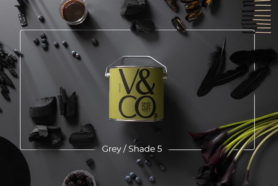a green tin of paint with V&CO branding against a charcoal grey background
