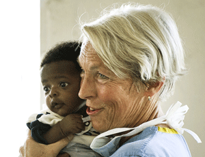 Smile: a volunteer poses with a baby