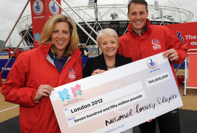 Dianne Thompson (centre), chief executive of Camelot, hands a cheque for £750m to former Olympian Sally Gunnell and former Paralympian Danny Crates