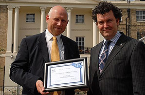 FSB chief executive Jon Scourse (left) presents a commemorative certificate to Royal Hospital for Neuro-disability director of fundraising Gaz Daly.