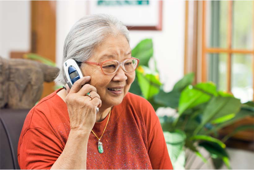 Lady on the phone, depicting Age UK's Telephone Friendship Service