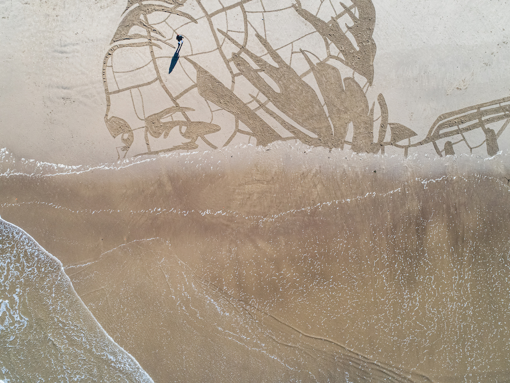 In March 2021 WaterAid created a giant sand portrait on Whitby Beach to show how climate change is impacting people’s access to water (Photo: WaterAid/Jon Snow)