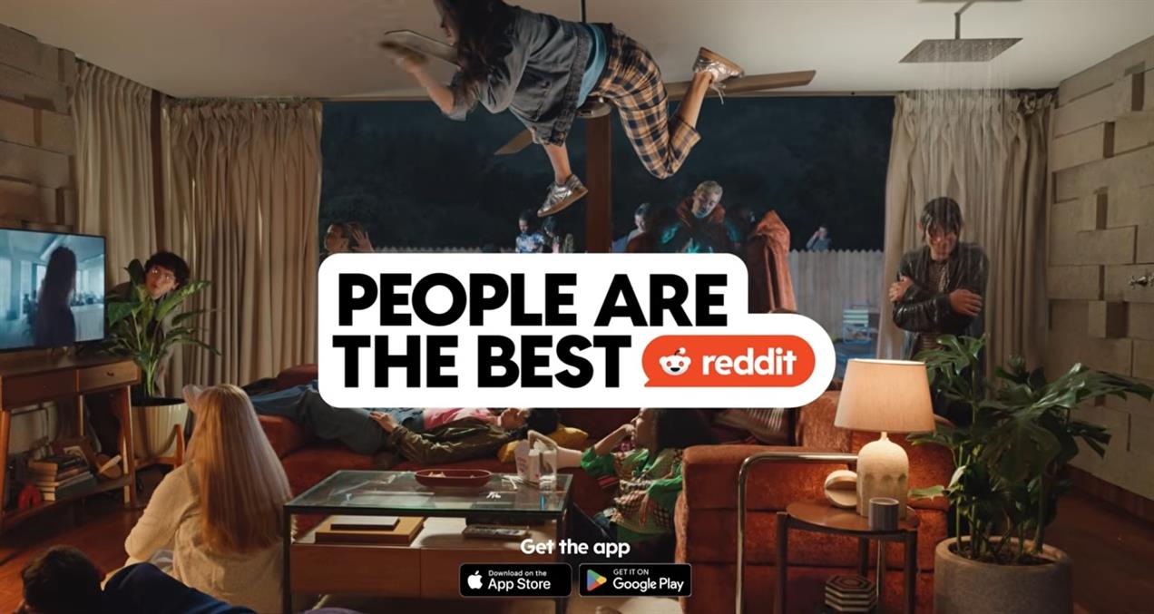 Reddit ad showing apartment filled with peopl, one is taking a shower in the living room, one hangs from a ceiling fan, they all are watching TV