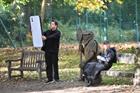 Picture of Dom Joly holding a giant phone in a park