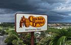 In an aerial view, a Cracker Barrel sign featuring the old logo hangs on a sign outside of a restaurant on August 27, 2025 in Florida City, Florida