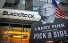 Protester holding picture of BlackRock's Larry Fink