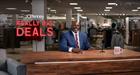 Shaquille O’Neal sits behind a desk at JCPenney