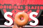 Hand holding Krispy Kreme donut as the O in SOS
