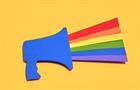 High angle view of a blue paper cutout megaphone with the LGTBQ flag coming out of it
