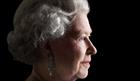 Queen Elizabeth II in profile in front of black background
