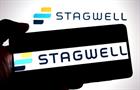 Hand holding smart phone displaying Stagwell logo
