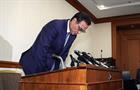Takeshi Niinami bows at a press conference in Tokyo