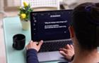Woman using AI assistant on laptop
