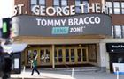 Image of actor Tommy Bracco in front of a theater