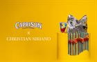 A silver Capri Sun pouch rests on a braided display on a raised yellow plinth