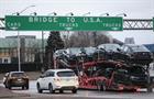 A car hauler heads to cross the Ambassador Bridge between Windsor, Canada and Detroit, Michigan 
