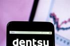 Dentsu logo on a smartphone